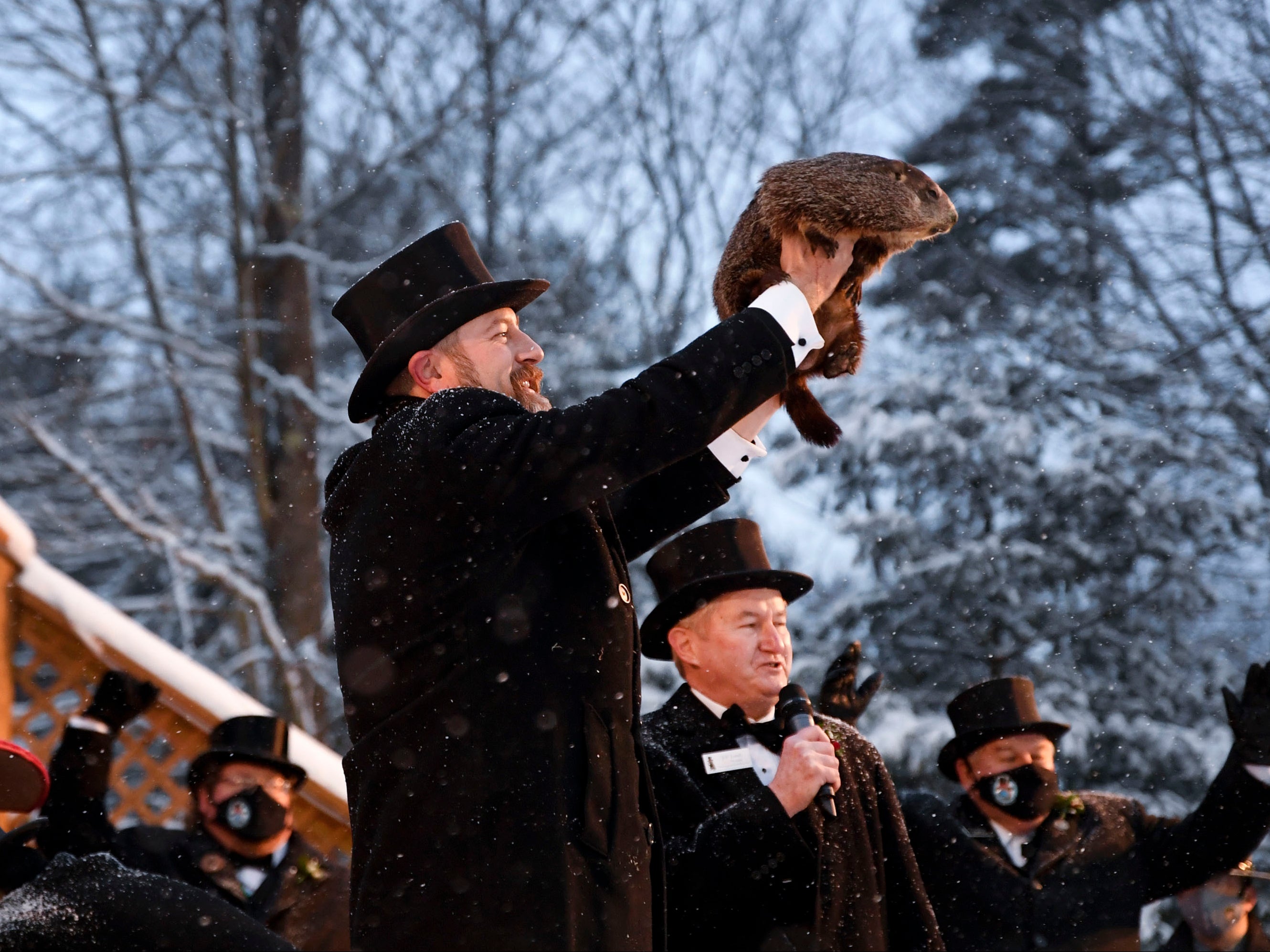 <p>Groundhog Club handler A.J. Dereume holds Punxsutawney Phil, the weather prognosticating groundhog, during the 135th celebration of Groundhog Day on Gobbler’s Knob in Punxsutawney, on Tuesday 2 February 2021</p>