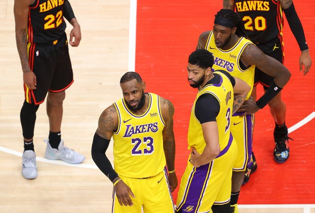 LeBron James of the Los Angeles Lakers reacts to a fan courtside during the second half against the Atlanta Hawks at State Farm Arena