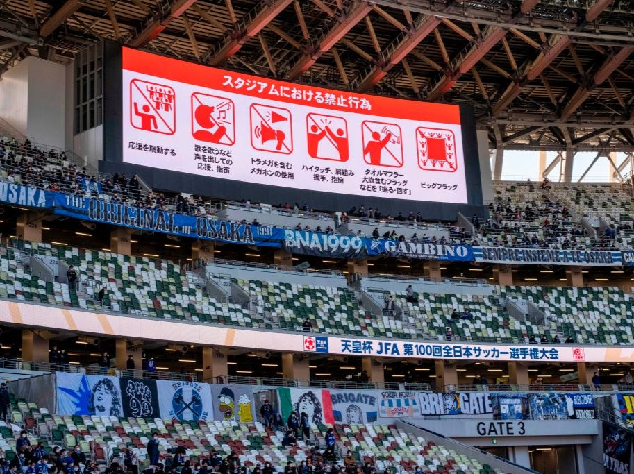 A screen displays Covid protocols during the Emperor's Cup final in Toyko