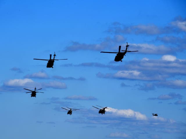 Black Hawk and Chinook helicopters fly during the “Hawk Strike 2020” joint military exercise. 