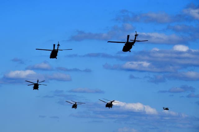 Black Hawk and Chinook helicopters fly during the “Hawk Strike 2020” joint military exercise. 