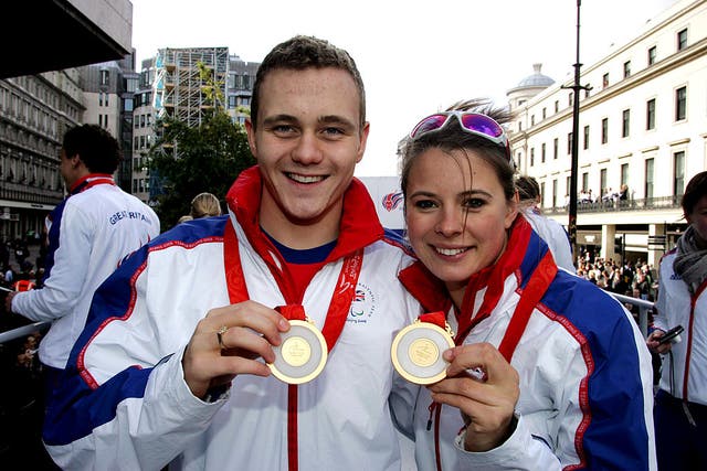 <p>Liz Johnson and Sam Hynd pose with their medals during Britain’s Beijing Olympics medal-winners’ parade in London on 16 October 2008</p>