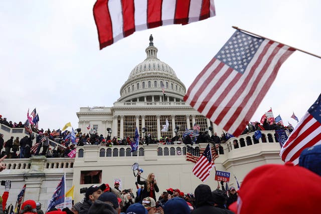 <p>In this Wednesday 6 January 2021 file photo, supporters of Donald Trump gather outside the US Capitol in Washington, DC</p>