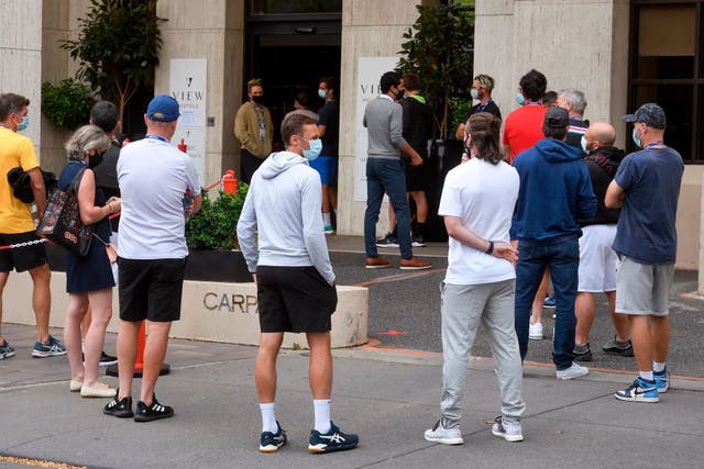 Tennis players queue for a Covid-19 coronavirus test at a hotel in Melbourne