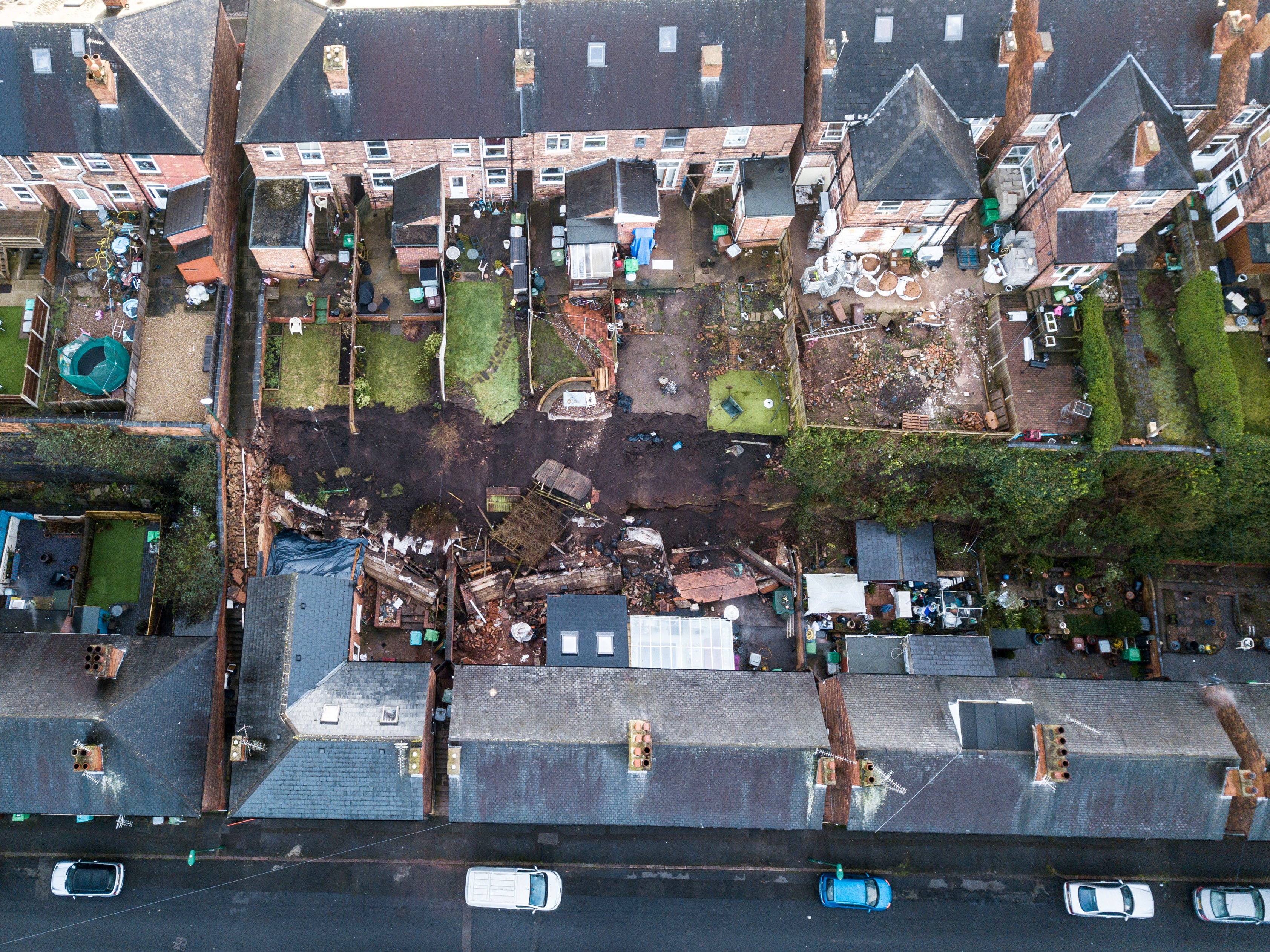 Five families were evacuated from their homes in the middle of the night after a “landslide” caused a 70ft wall to collapse into their properties