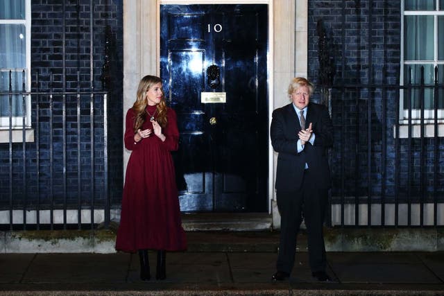 <p>Johnson and his partner Carrie Symonds pay tribute to Captain Tom  outside No 10</p>