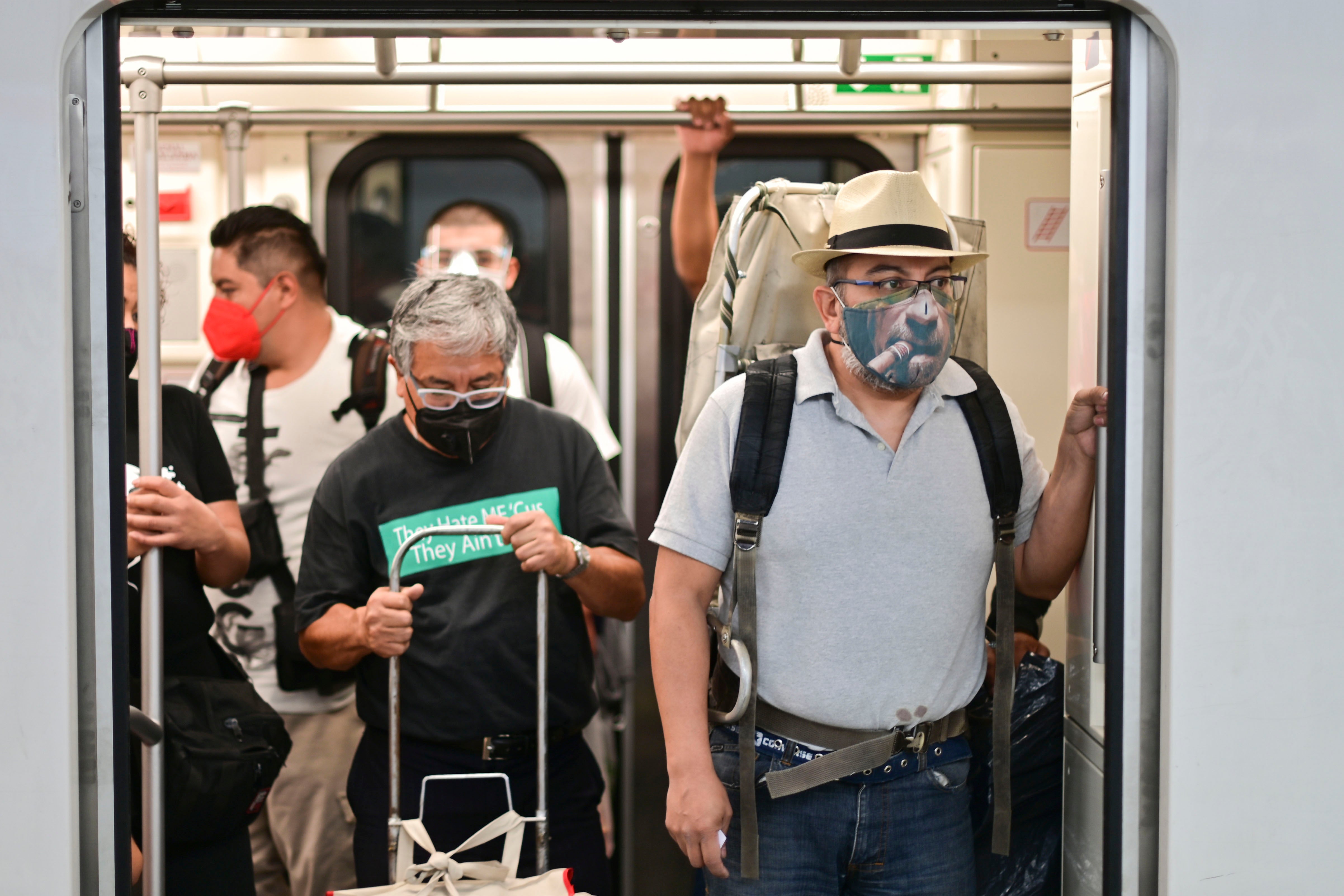 Commuters wear masks in a Mexico City subway