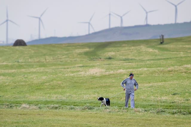 <p>Going back in time. A man walks his dog in Whitehaven, Cumbria, near the site of the proposed coal mine </p>
