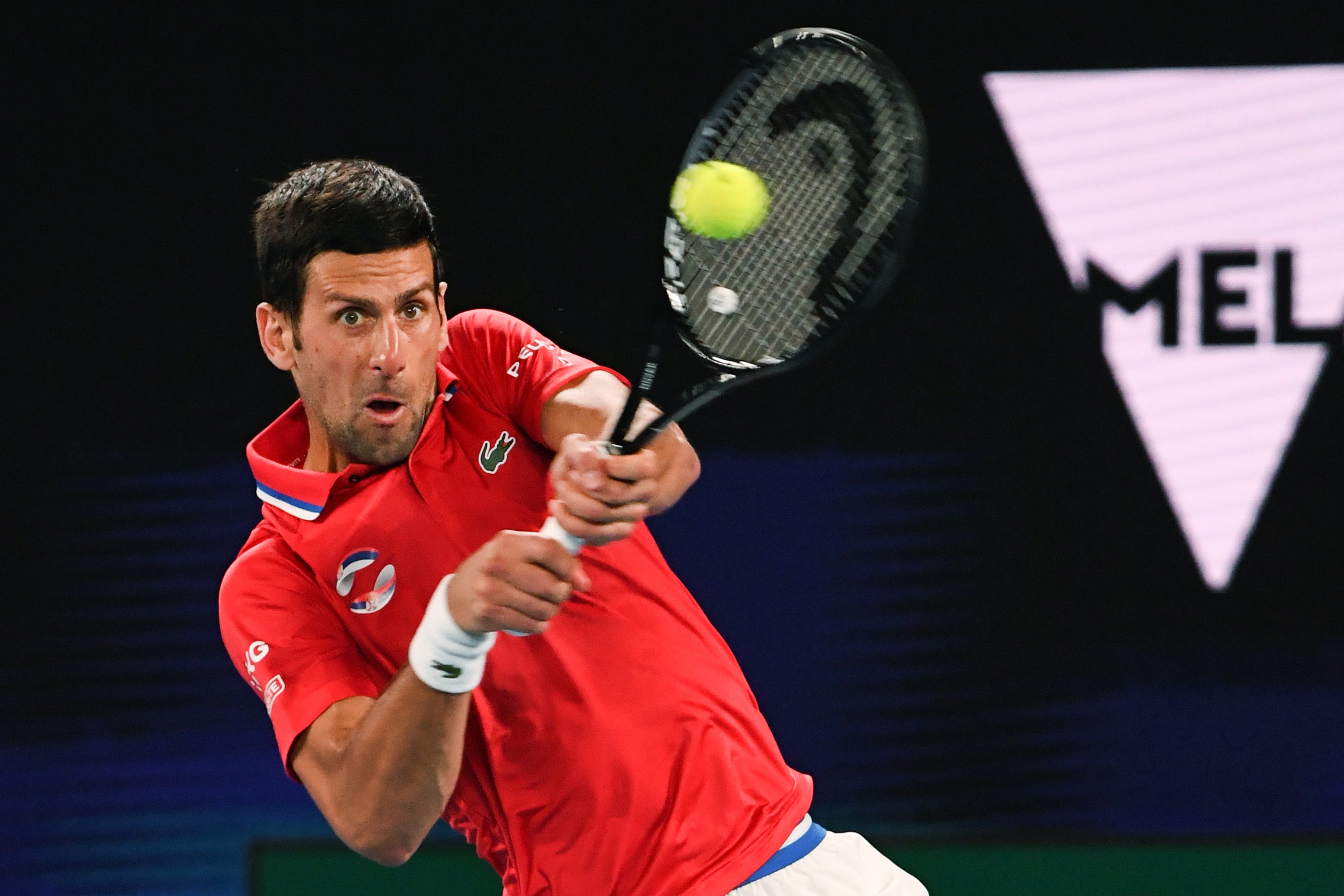 Novak Djokovic hits a return against Alexander Zverev during their ATP Cup match