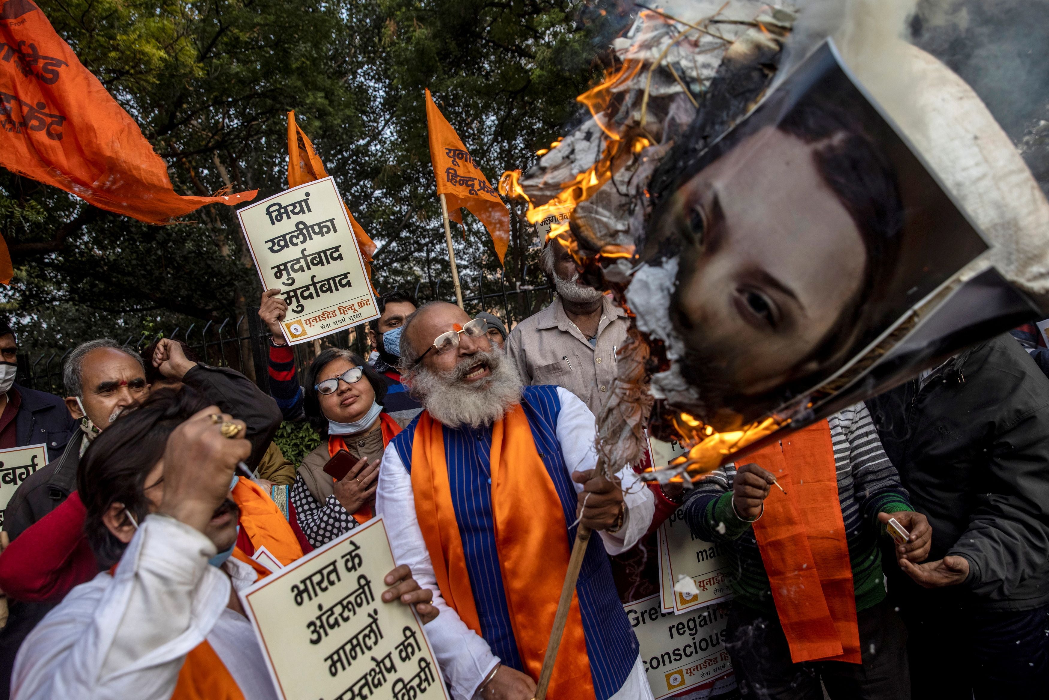 Activists from United Hindu Front burn an effigy depicting climate change activist Greta Thunberg to protest against celebrities commenting in support of protesting farmers