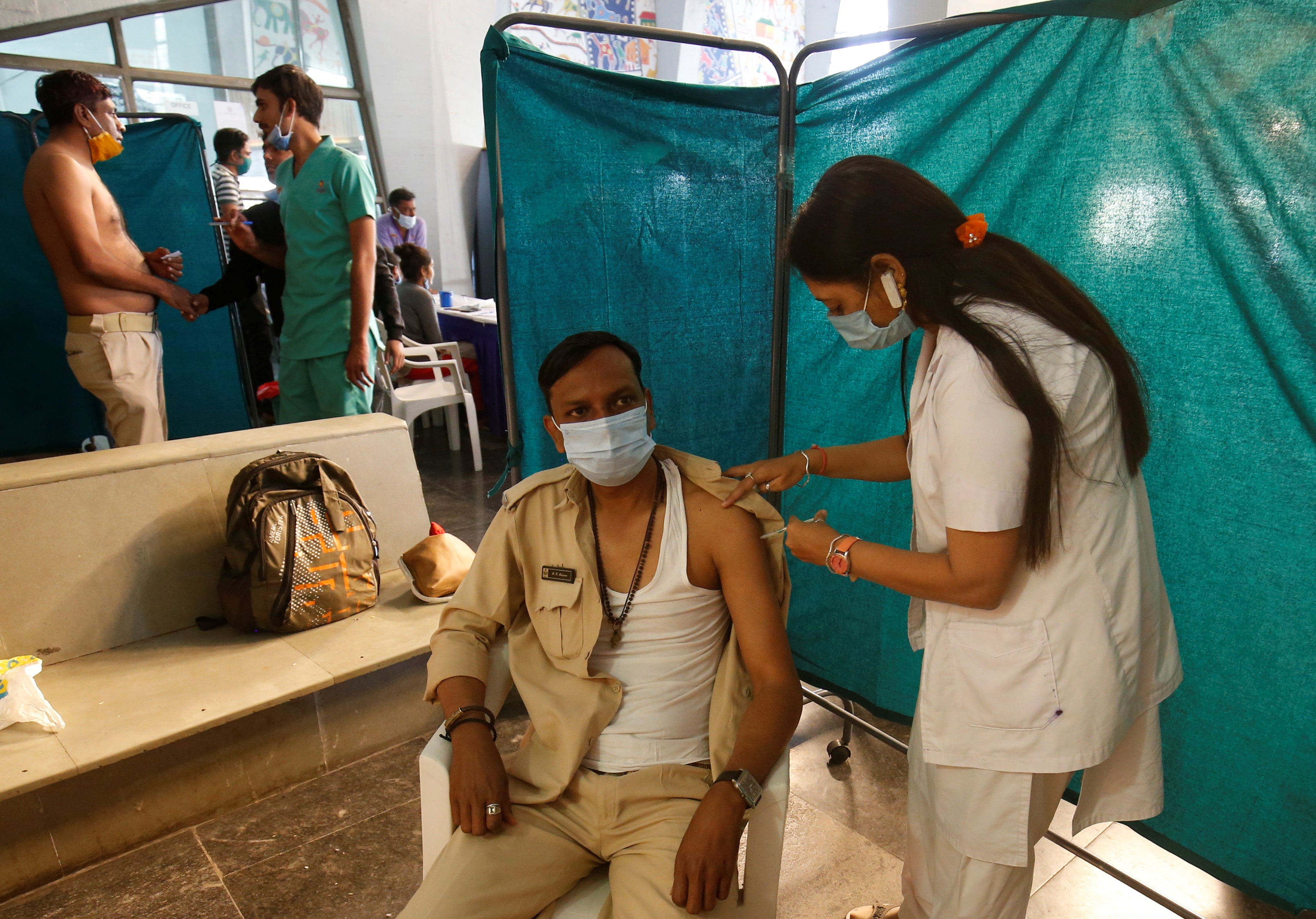A policeman receives a dose of Covid-19 vaccine at a vaccination centre in Ahmedabad, India