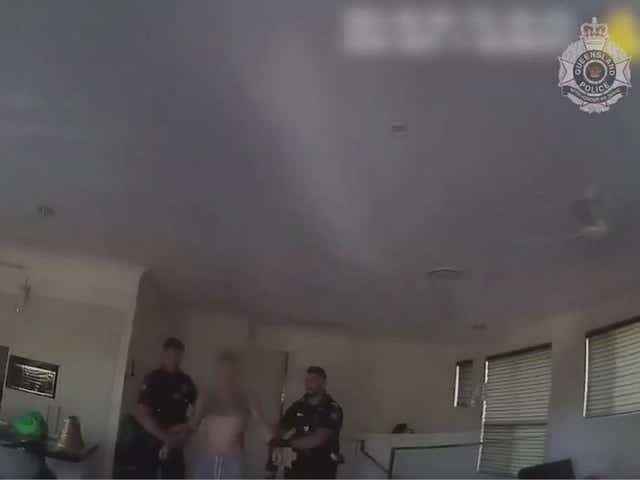 Screen grab from video released by Queensland Police of a man being arrested in Brisbane on suspicion of running a prostitution ring