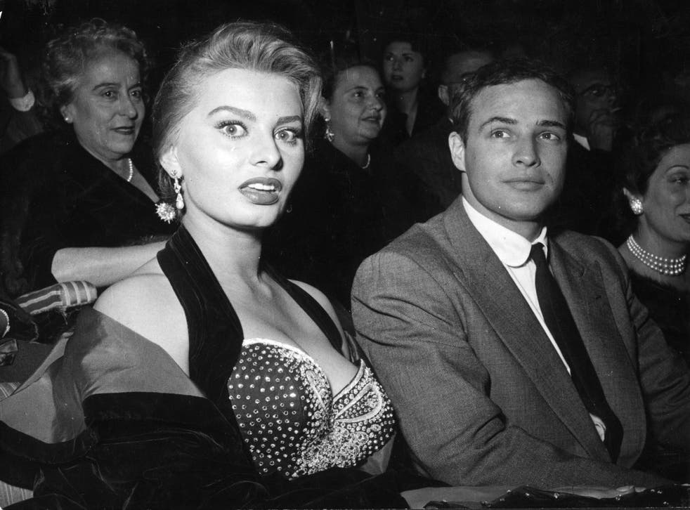 <p>Loren and Marlon Brando at a cinema in Rome in 1954</p>