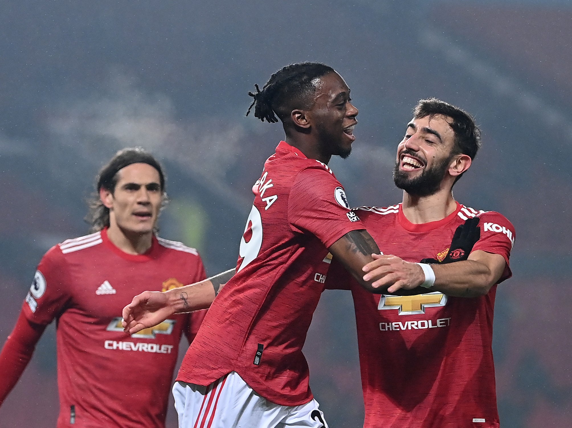 Bruno Fernandes (right) celebrates with Aaron Wan-Bissaka and Edinson Cavani (left)