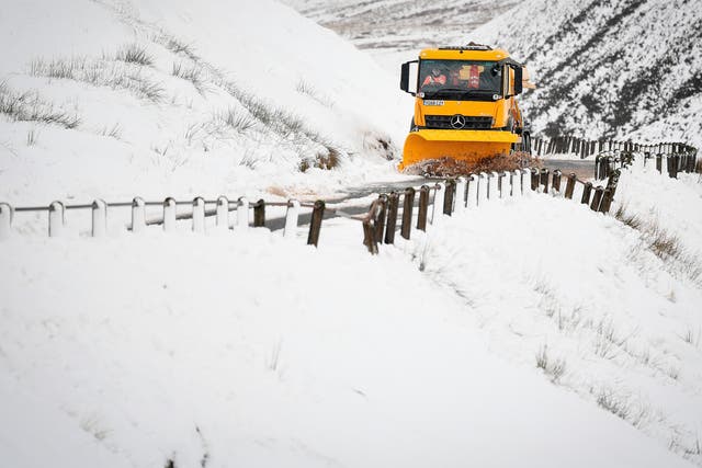 A snow plough clears the A708 in the Scottish Borders as Storm Darcy approaches