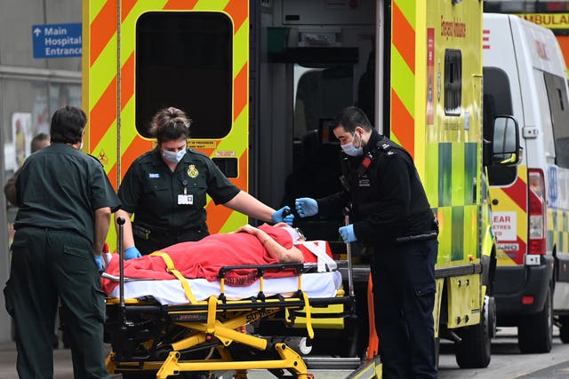 <p>Ambulance staff bring a patient into the Royal London hospital</p>