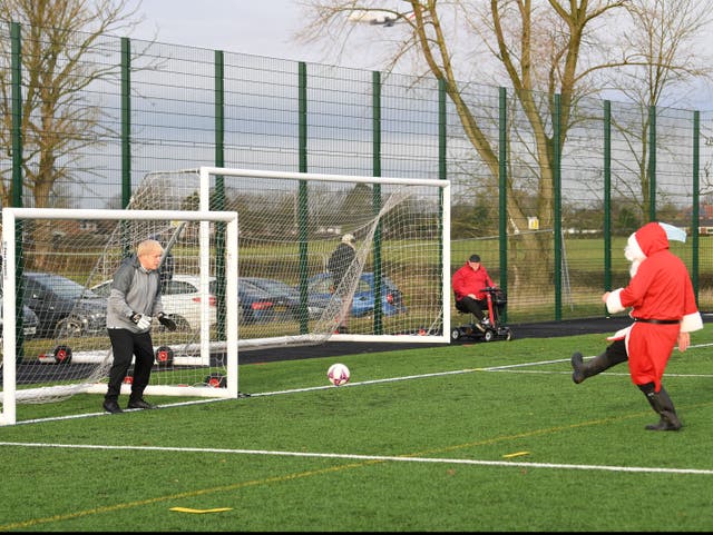 <p>Boris Johnson tries out goalkeeping in Cheshire after pledging £550m investment in grassroots football in December 2019</p>