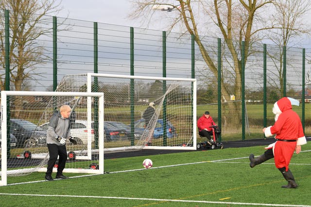 <p>Boris Johnson tries out goalkeeping in Cheshire after pledging £550m investment in grassroots football in December 2019</p>