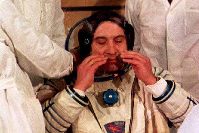 <p>Technicians help Russian cosmonaut Valery Polyakov don his helmet before his Soyuz TM-18 spacecraft lifted off from the Baikonur cosmodrome with three cosmonauts on board on 8 January 1994</p>