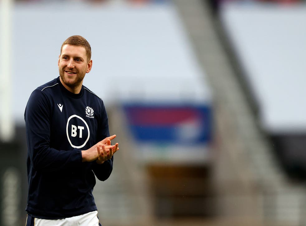 Scotland's fly-half Finn Russell warms up