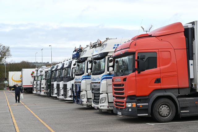 Freight lorries are parked at a truck stop off the M20 leading to Dover near Folkestone in Kent, south east England on 22 December, 2020, Hauliers say exports plunged by 68 per cent last month compared with January of last year. 