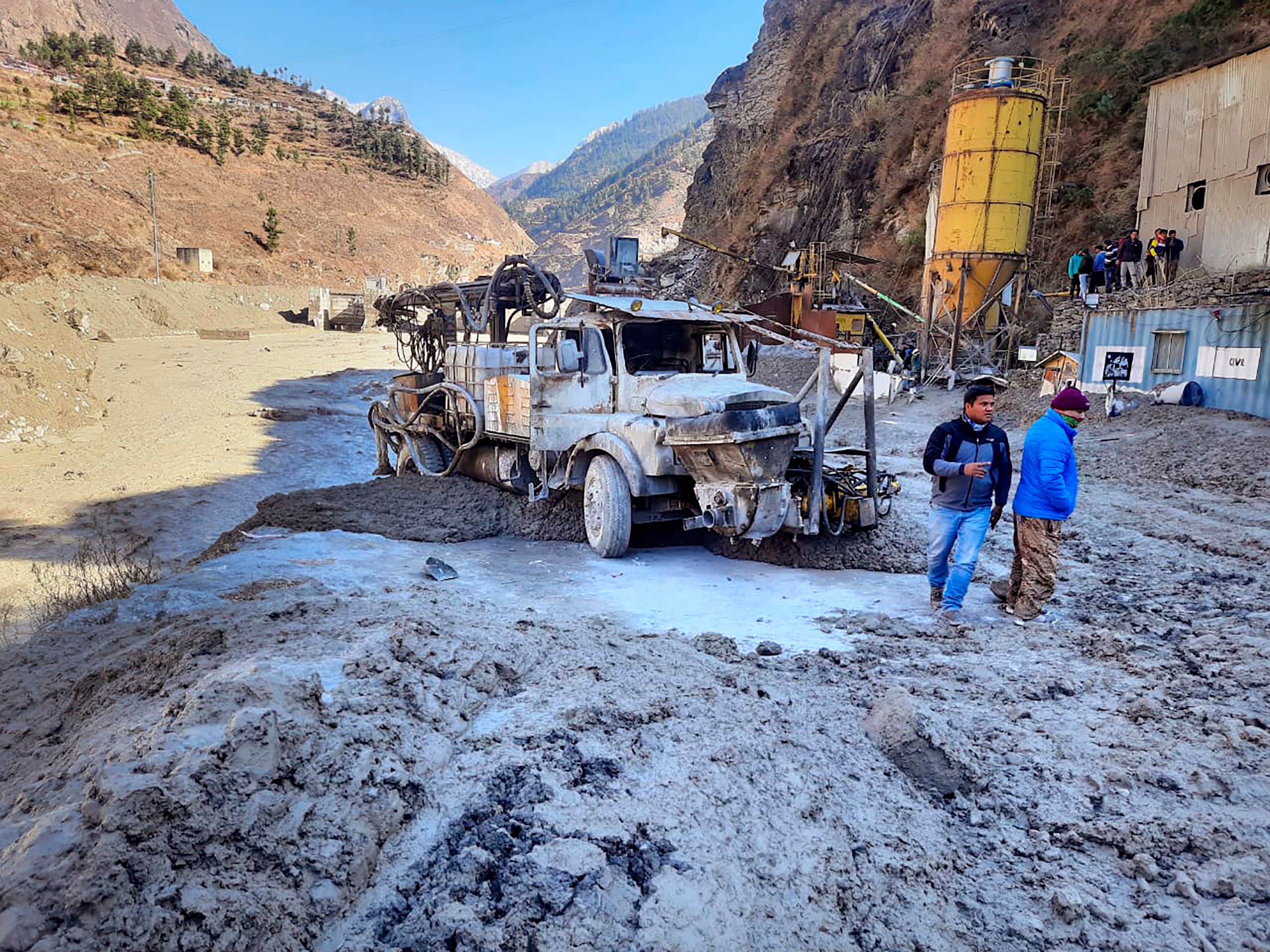 People inspect the site near the damaged Dhauliganga hydropower project at Reni village in Chamoli district after massive floods in the northern state of Uttarakhand, swept away the whole area