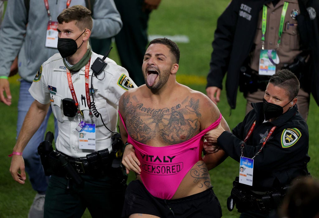 A pitch invader is chased during the fourth quarter