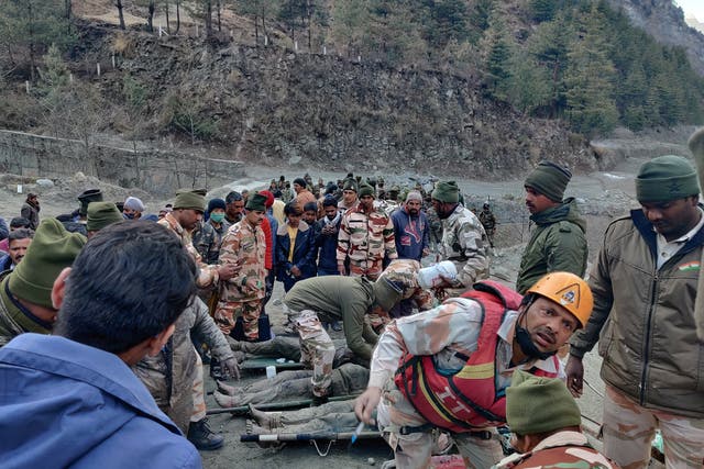 <p>Members of Indo-Tibetan Border Police tend to people rescued after a Himalayan glacier broke and swept away a small hydroelectric dam, in northern India</p>