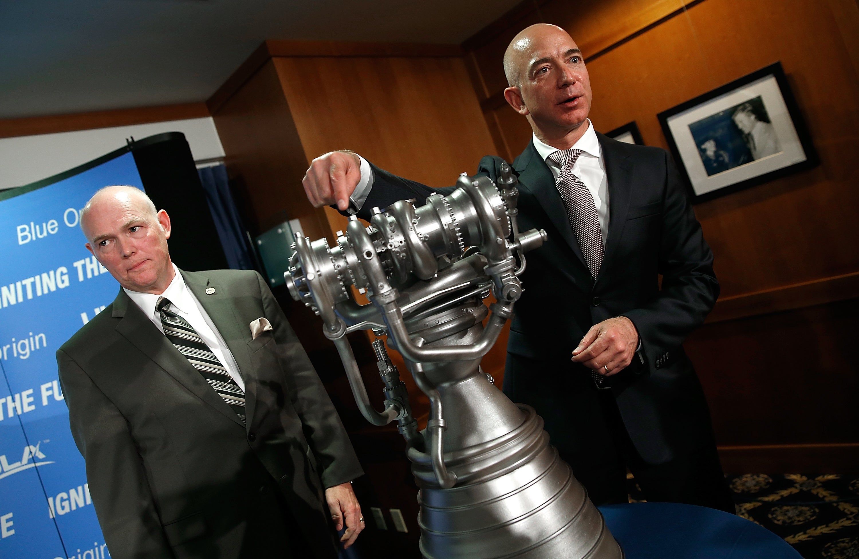 Bezos with the new BE-4 rocket engine during a press conference