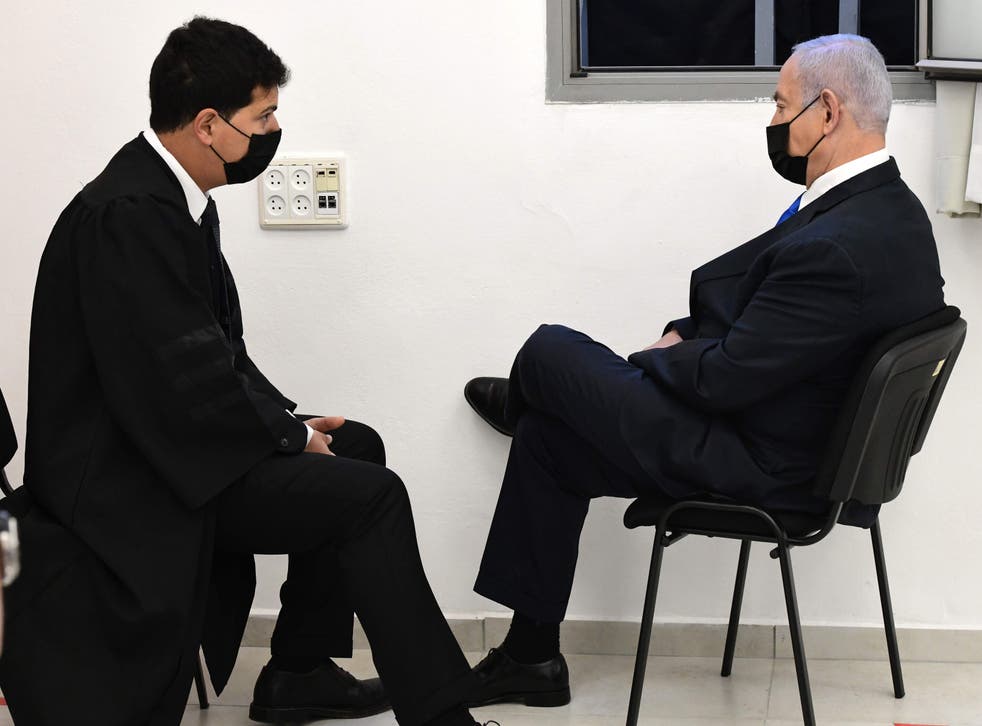 Mr Netanyahu talks to his lawyer