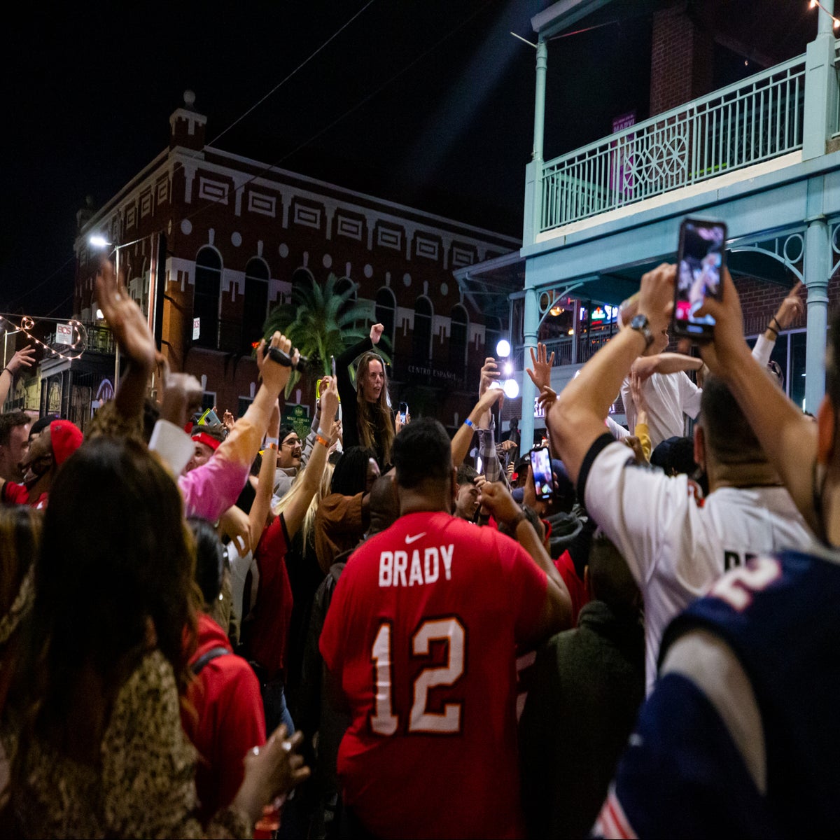 Maskless fans celebrate the Super Bowl in Tampa's streets. - The