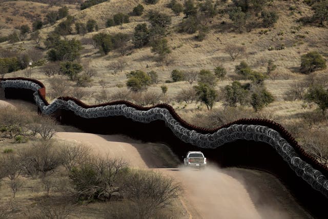 <p>The US side of a razor-wire-covered border wall along the Mexico east of Nogales, Arizona</p>