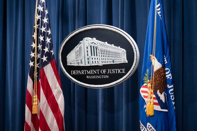 A sign for the Department of Justice is seen ahead of a news conference with Michael Sherwin, acting US attorney for the District of Columbia, and Steven D’Antuono, head of the Federal Bureau of Investigation (FBI) Washington field office, at the US Department of Justice in Washington, DC, on 12 January 2021