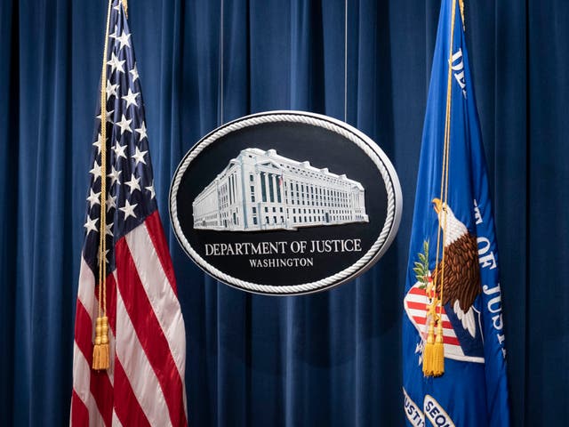 A sign for the Department of Justice is seen ahead of a news conference with Michael Sherwin, acting US attorney for the District of Columbia, and Steven D’Antuono, head of the Federal Bureau of Investigation (FBI) Washington field office, at the US Department of Justice in Washington, DC, on 12 January 2021