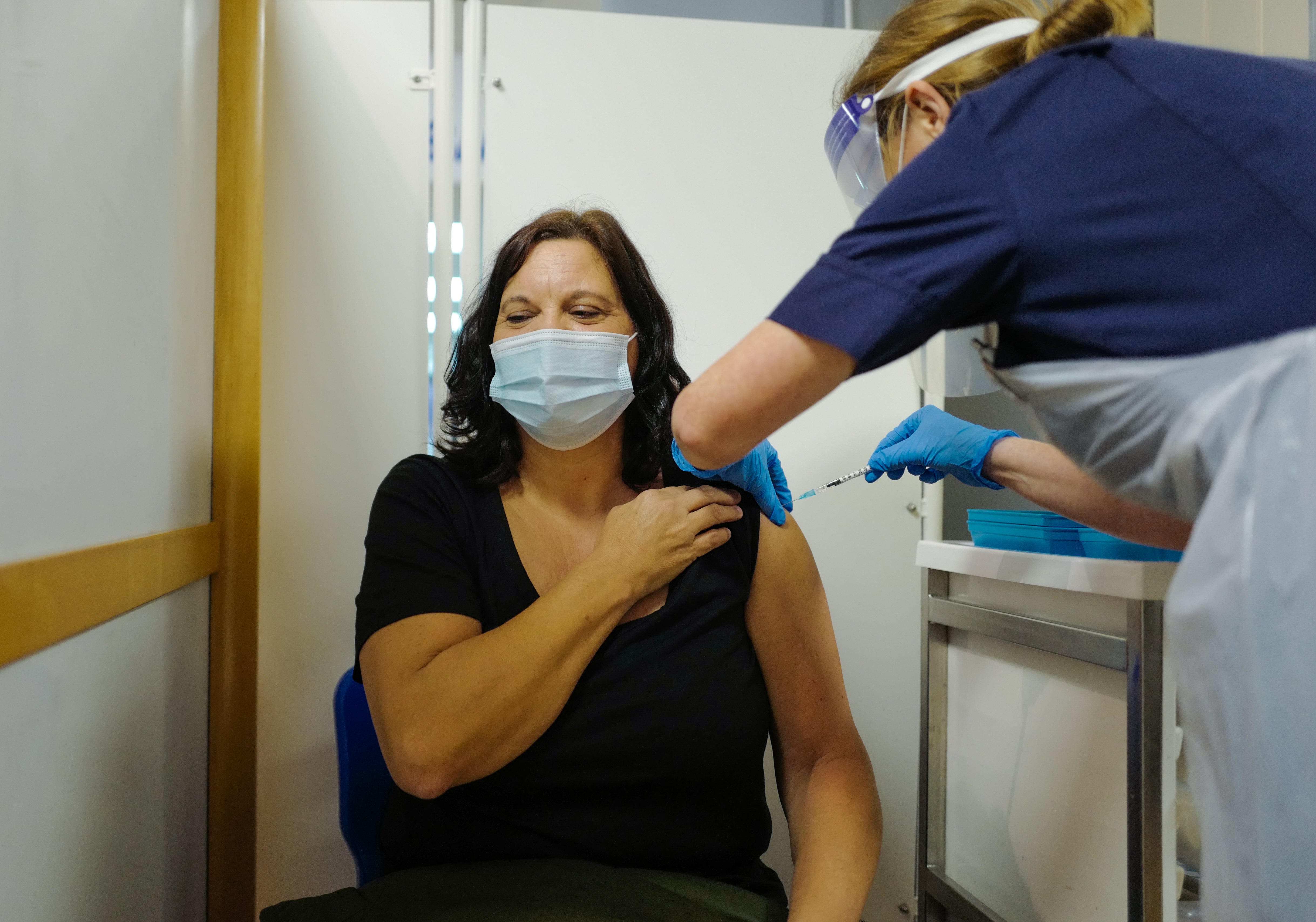 A woman receives a vaccine dose at the Royal Cornwall Hospital on 9 December 2020