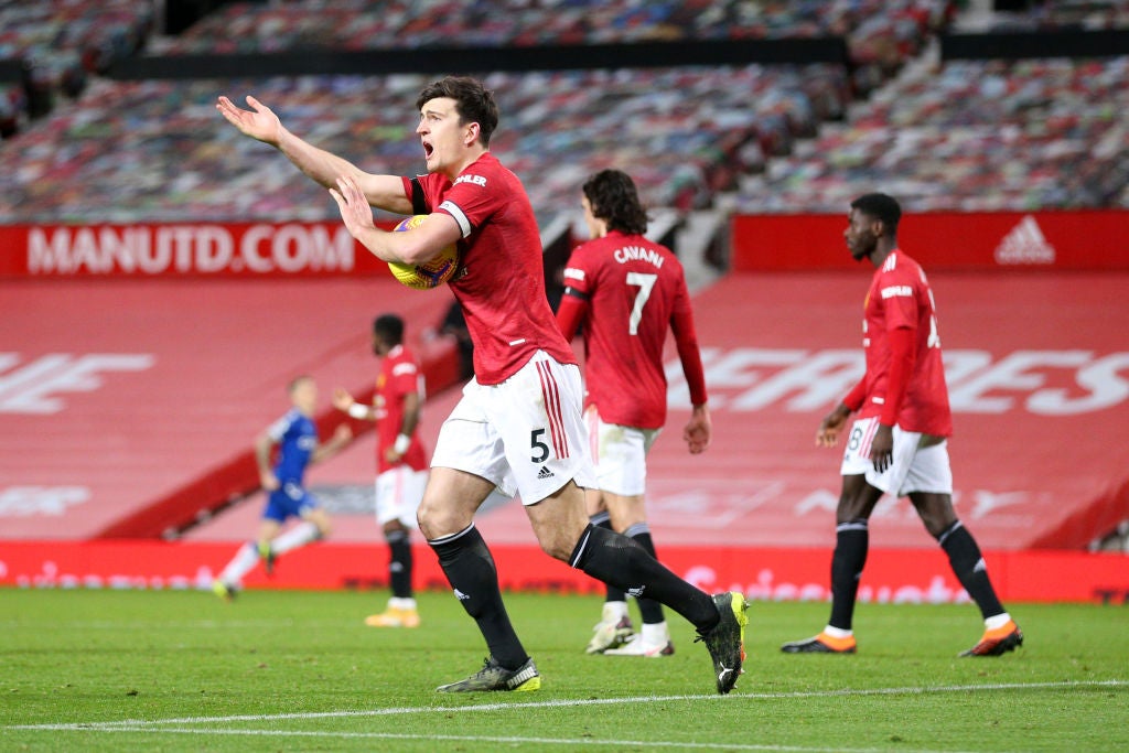 Harry Maguire gestures to the assistant referee for a handball decision after Everton’s third goal