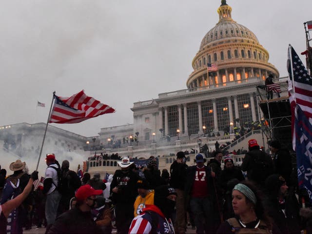 Police clear the US Capitol Building with tear gas as supporters of Donald Trump gather outside, in Washington on 6 January, 2021