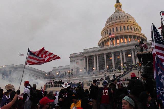 Police clear the US Capitol Building with tear gas as supporters of Donald Trump gather outside, in Washington on 6 January, 2021