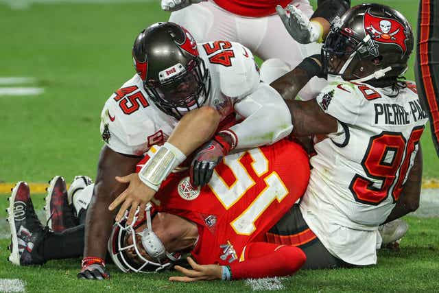 <p>Patrick Mahomes is tackled by Jason Pierre-Paul and Devin White</p>