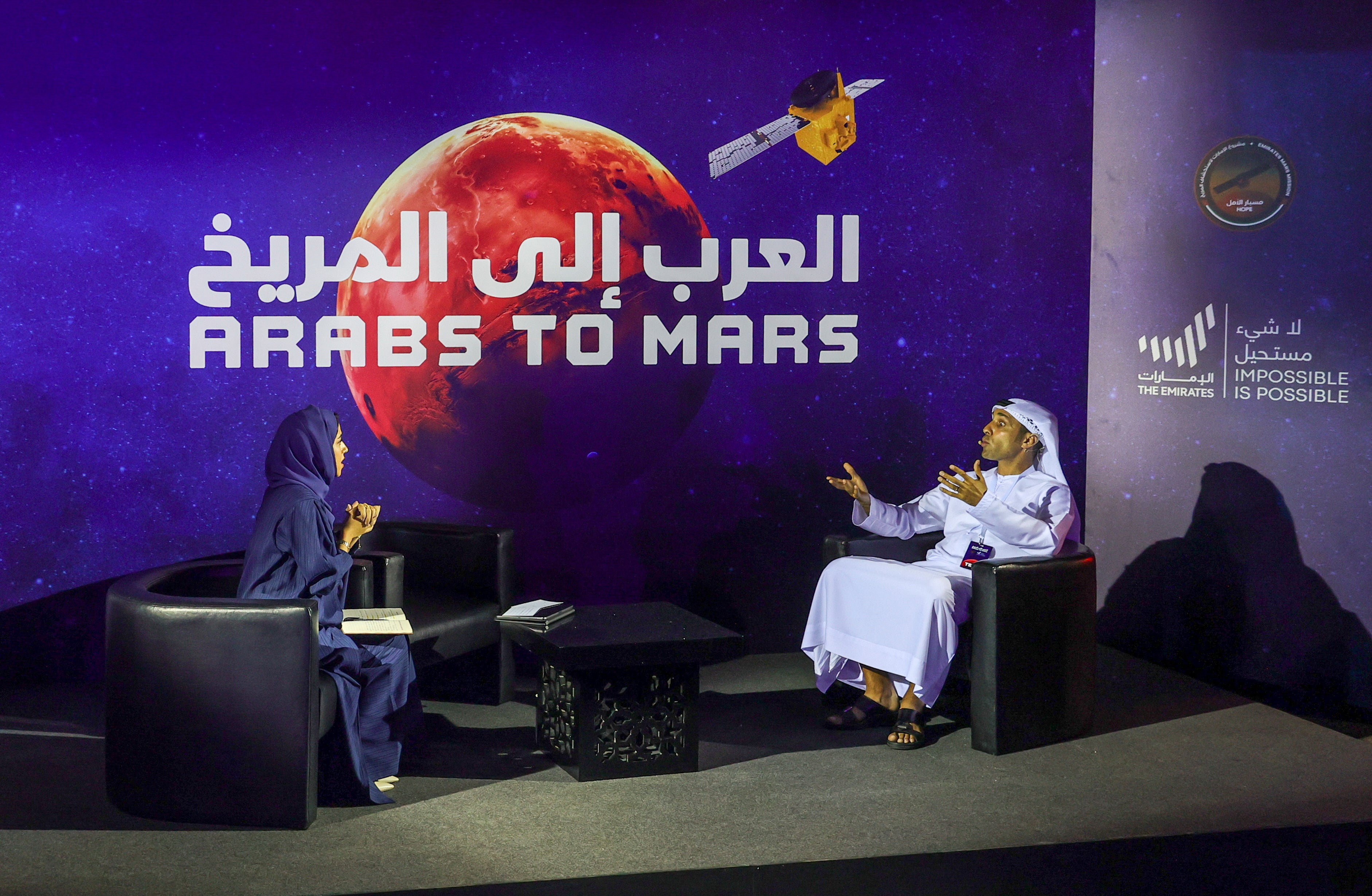 News reporters talk during an event in Dubai to mark the ‘Hope’ probe's entry into the orbit of Mars