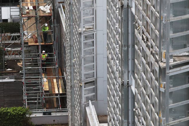 <p>Contractors undertake works at a residential property in Paddington, London, as part of a project to remove and replace non-compliant cladding</p>