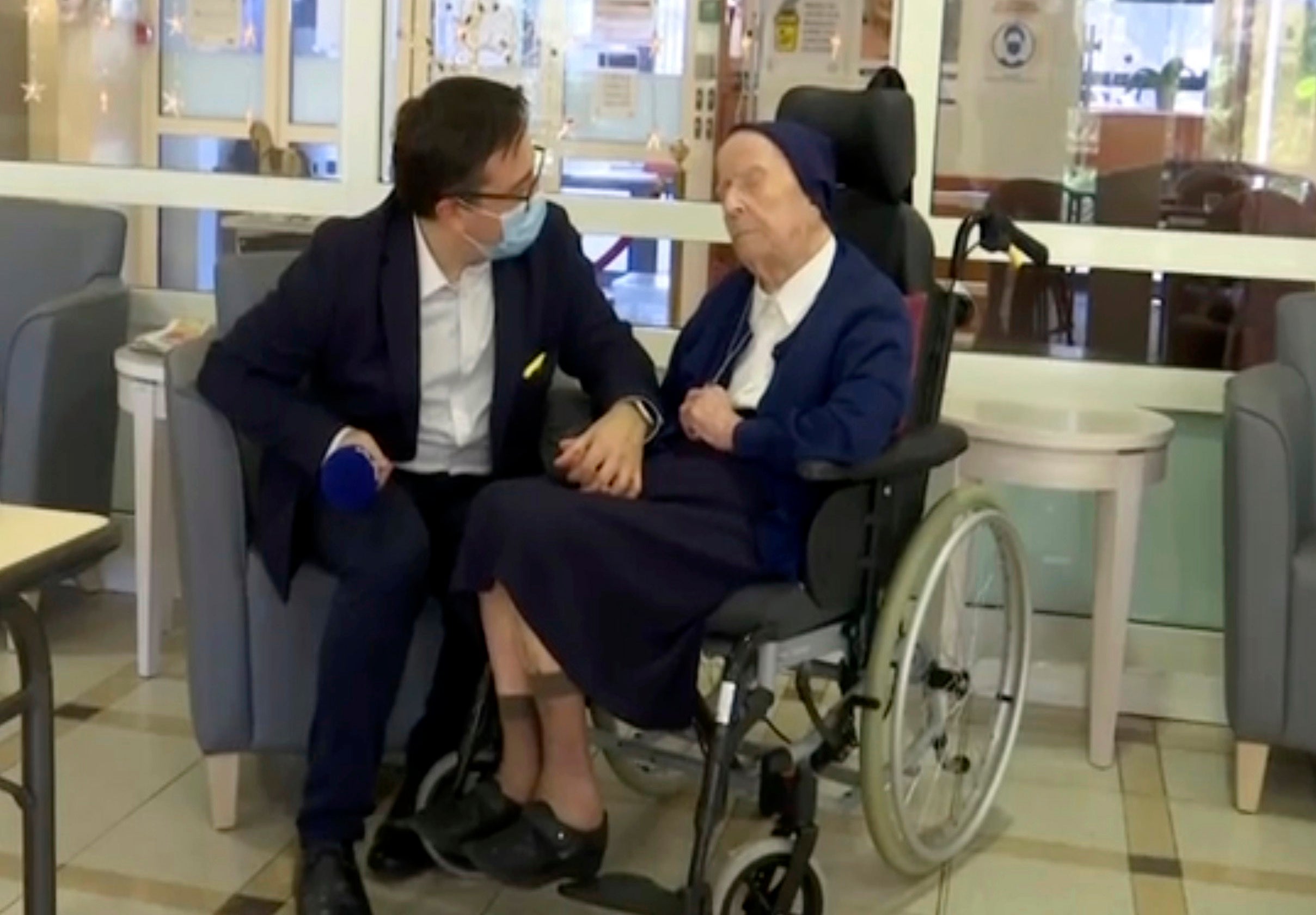 In this image made from BFM TV video, Sister Andre, born Lucile Randon, is interviewed by David Tavella, Communications Manager for the Sainte Catherine Laboure Nursing Home in Toulon, France, Tuesday Feb. 9, 2021.