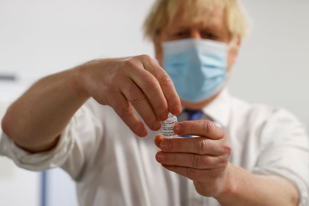 Boris Johnson holds a vile of the Covid-19 vaccine. IPPR research has found immigration policy could jeopardise the UK's efforts to control the spread of the virus