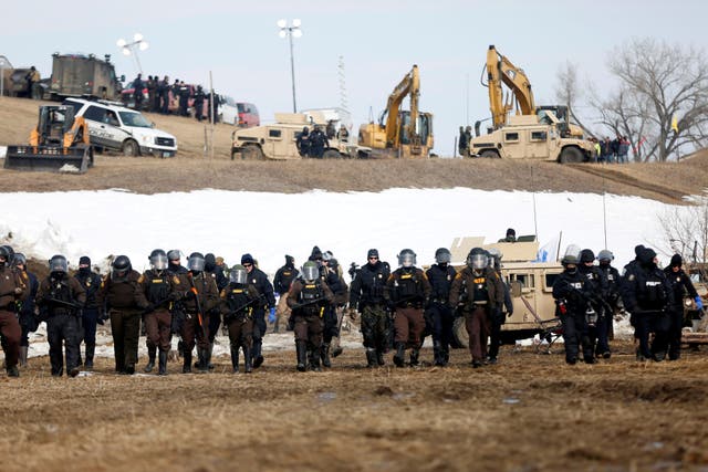 Law enforcement officers advance into the main opposition camp against the Dakota Access oil pipeline near Cannon Ball, North Dakota in February 2017