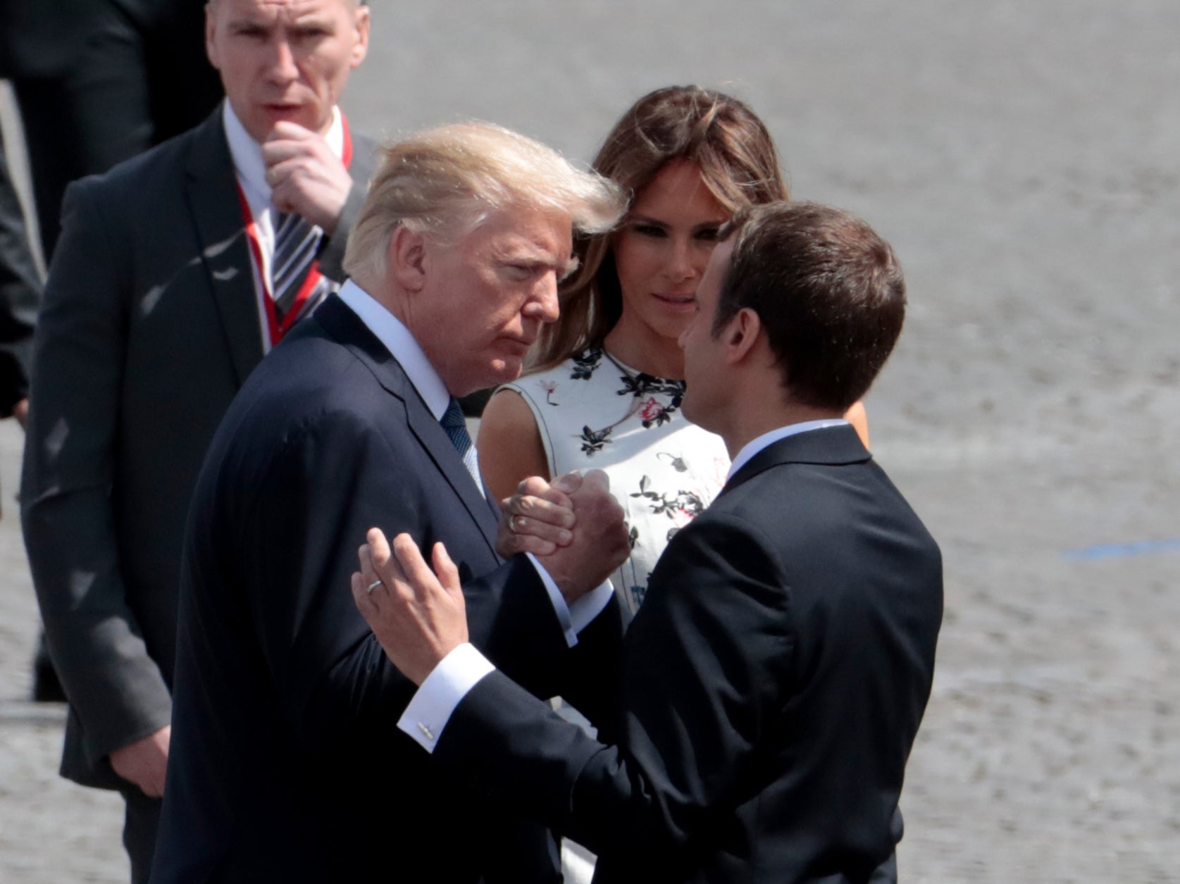 <p>French President Emmanuel Macron (R) bids farewell to US President Donald Trump (L) and  US First Lady Melania Trump, after the annual Bastille Day military parade on the Champs-Elysees avenue in Paris on 14 July 2017</p>