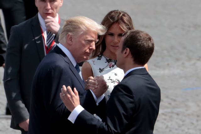 <p>French President Emmanuel Macron (R) bids farewell to US President Donald Trump (L) and  US First Lady Melania Trump, after the annual Bastille Day military parade on the Champs-Elysees avenue in Paris on 14 July 2017</p>