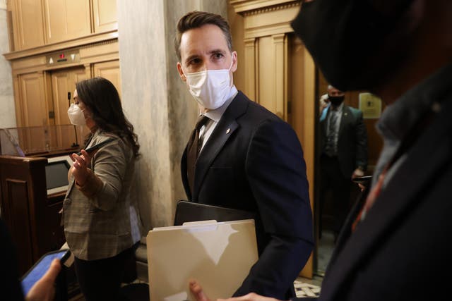 Senator Josh Hawley has been watching most of the Trump impeachment trial from the gallery above the chamber, going through paperwork, according to reports.