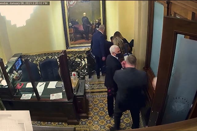 <p>In this image from video, security video showing Vice President Mike Pence being evacuated from the Senate chamber, is shown to senators, as House impeachment manager Rep. Eric Swalwell,</p>