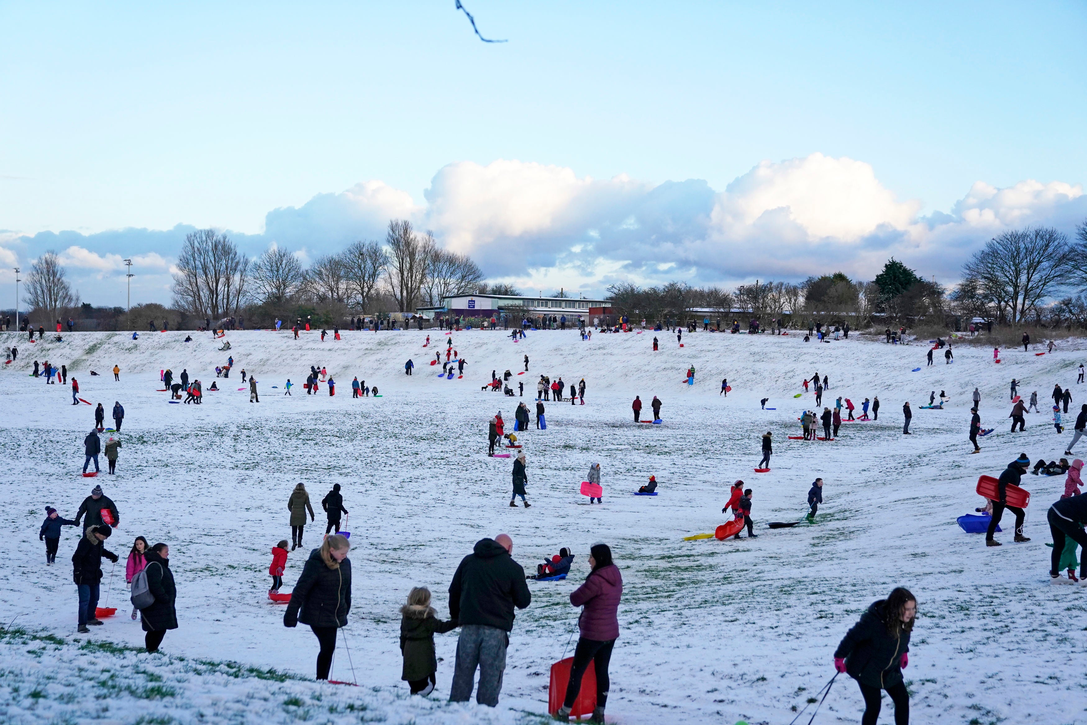 People sledging in a snow covered park in Whitley Bay