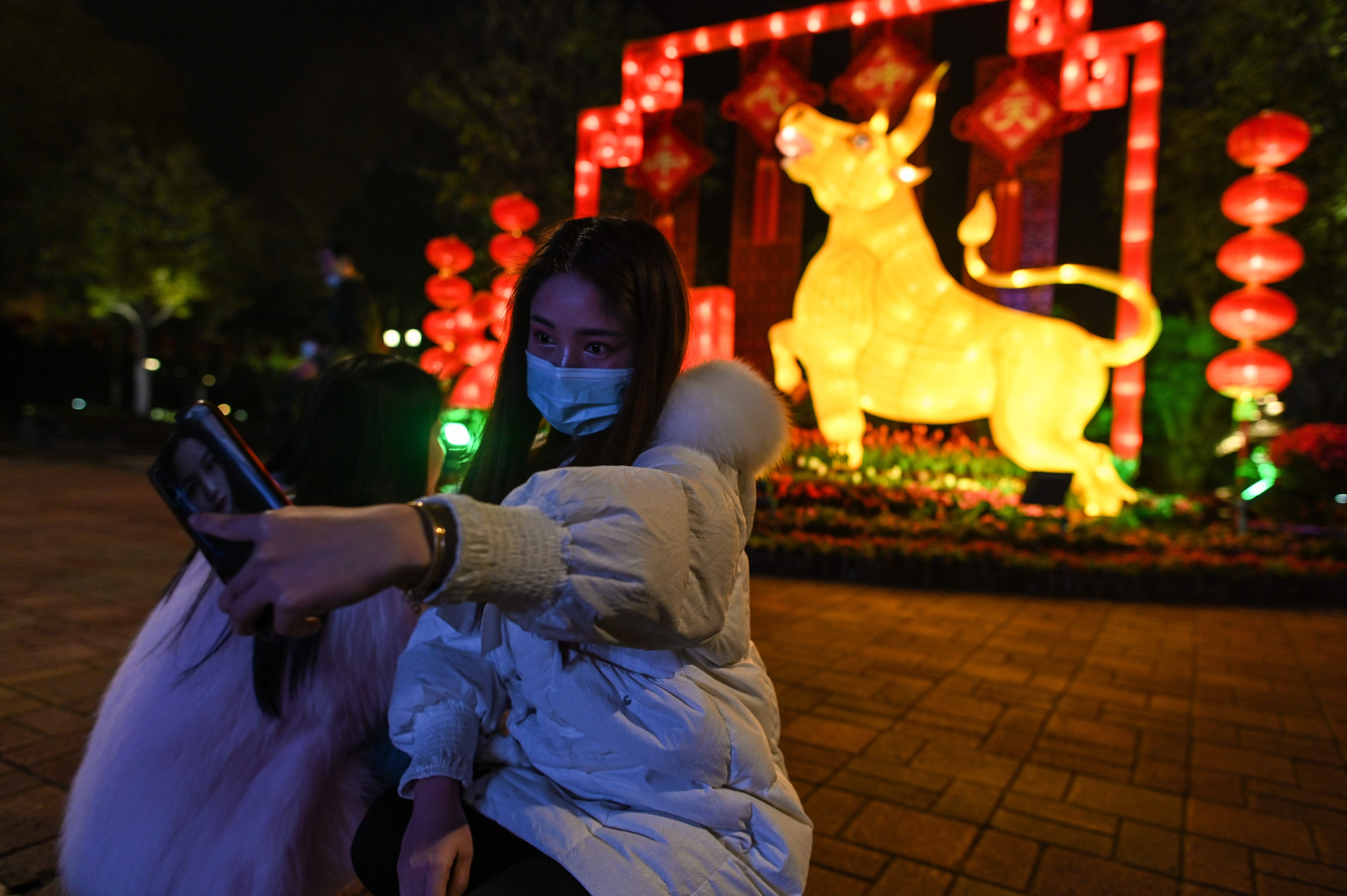 A young woman takes a selfie in Wuhan ahead of the Lunar New Year, which ushers in the Year of the Ox on Thursday
